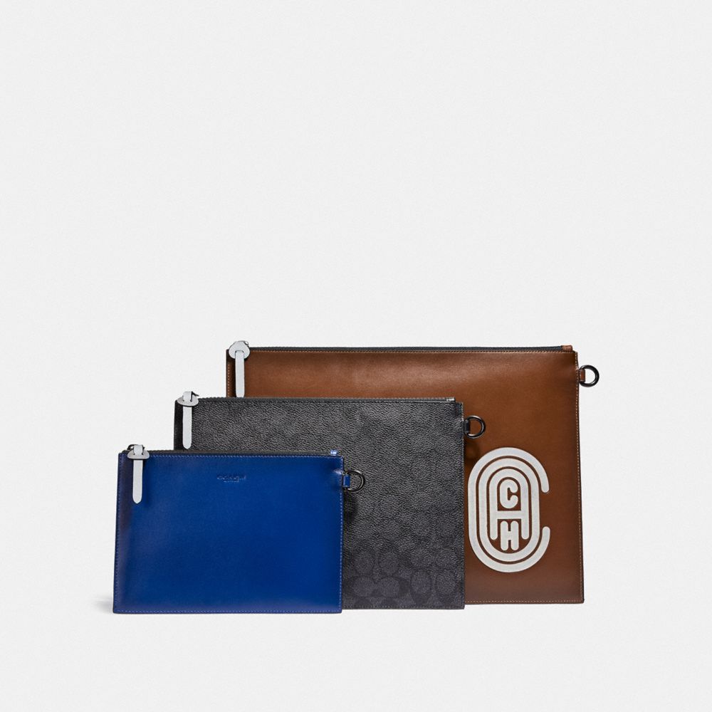 TRIPLE POUCH IN SIGNATURE CANVAS WITH REFLECTIVE COACH PATCH